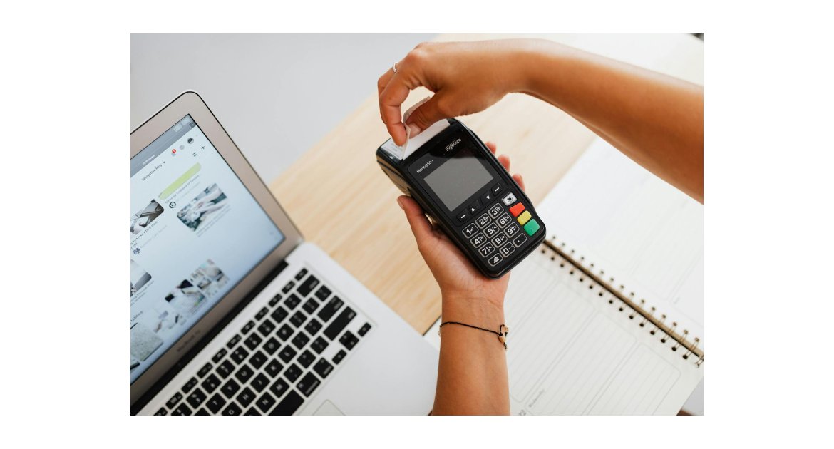 a person holding payment terminal