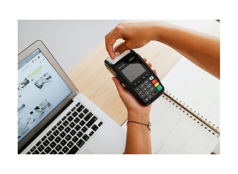 a person holding payment terminal